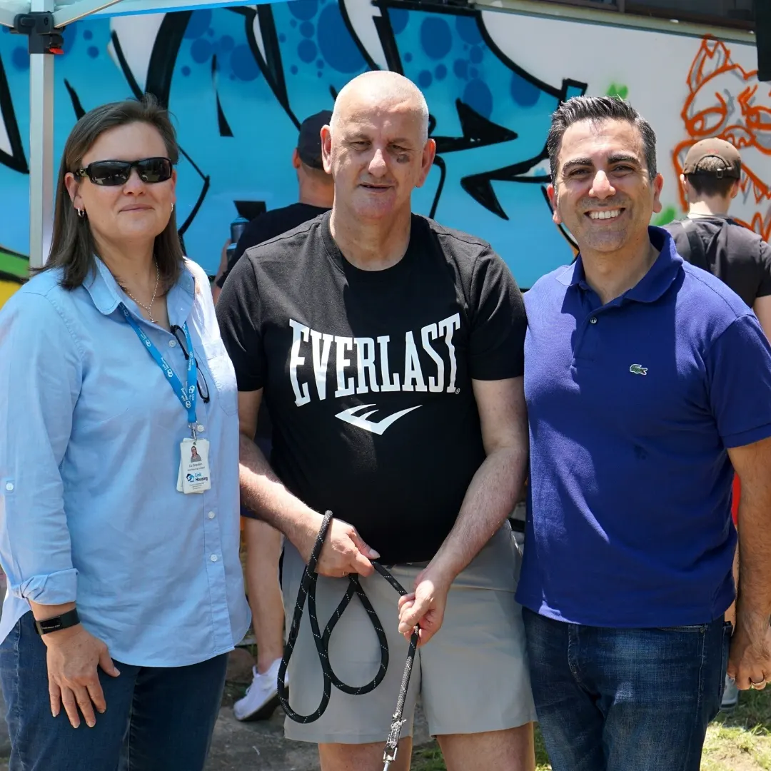 Dario (centre) with Liz and former staff member Pablo on the day the mural was painted
